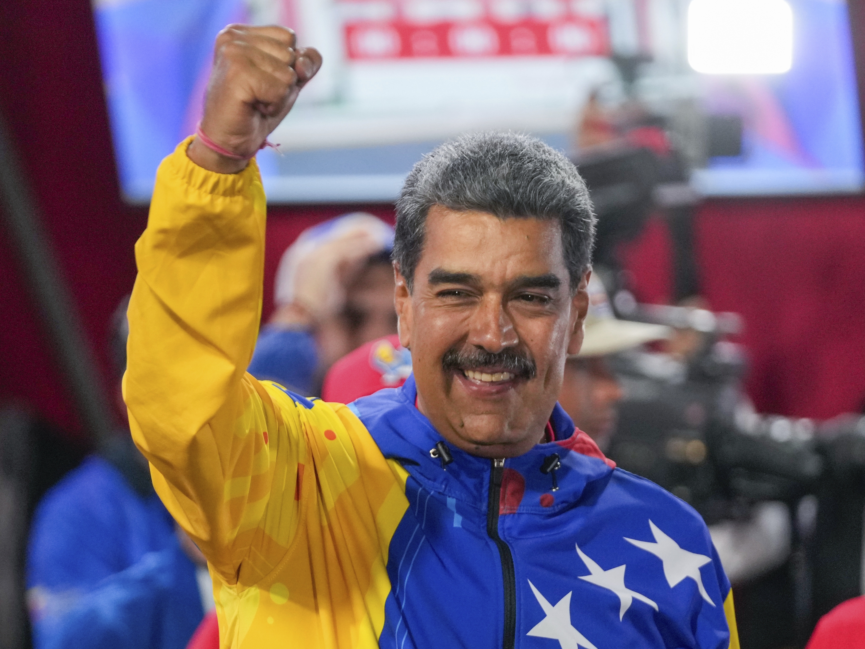 caption: President Nicolas Maduro addresses supporters after electoral authorities declared him the winner of the presidential election in Caracas, Venezuela on Monday. 