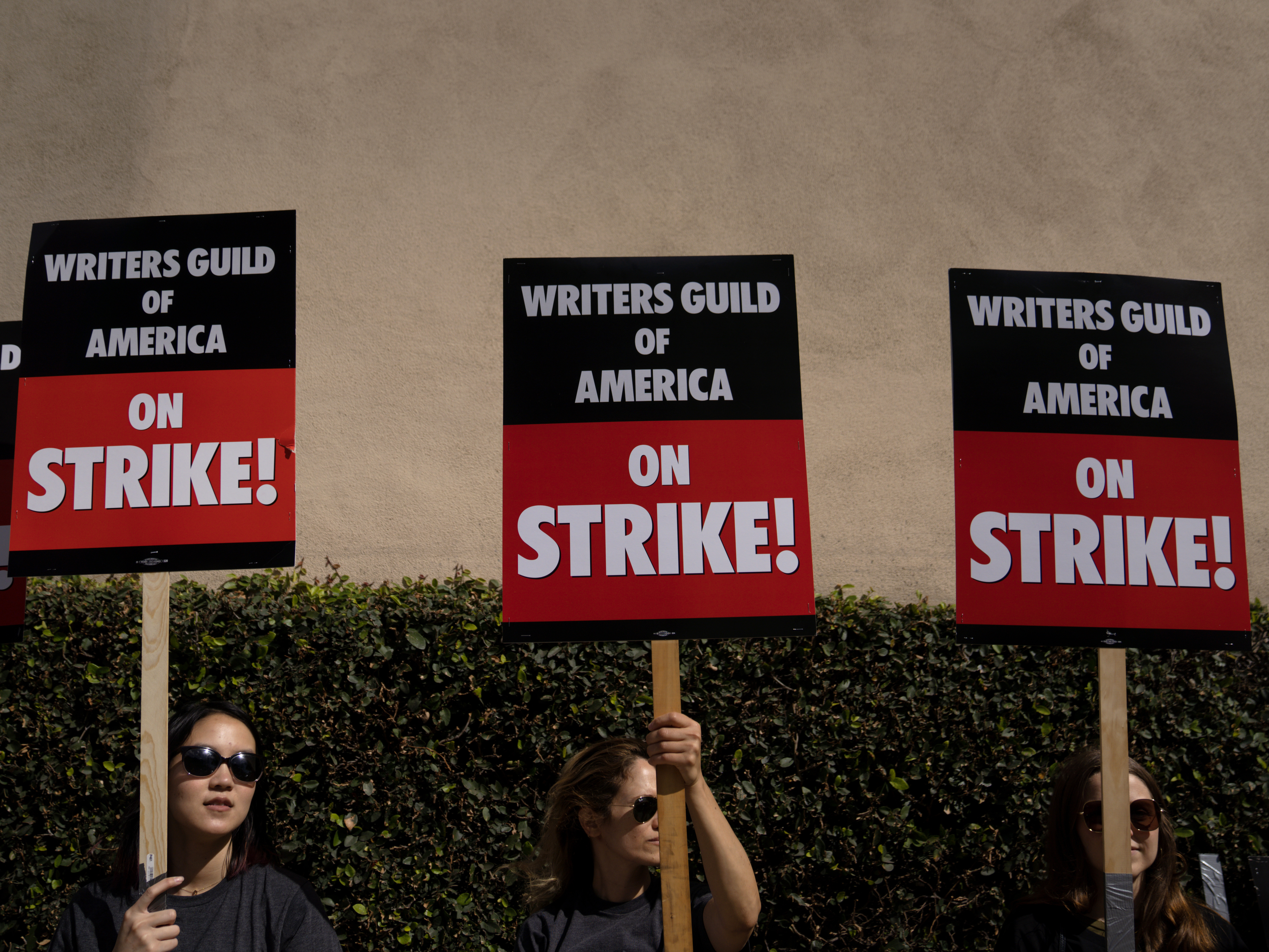 caption: Screenwriters around the world are organizing pickets and other actions on June 14 in support of the ongoing Writers Guide of America strike. Above, Writers Guild of America workers picket outside the Warner Brother studios, on May 2, 2023 in Burbank, Calif.