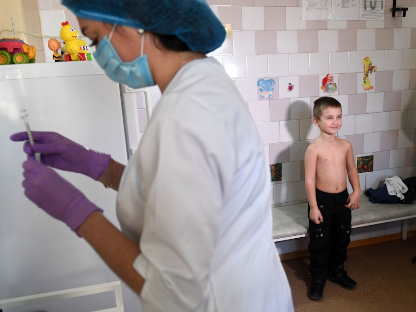 caption: A nurse prepares a syringe for a vaccination against measles at a pediatric clinic in Kiev. The Ukraine had 72,408 cases of measles in the year from March 2018 to February 2019 — the highest number for any country during that period.