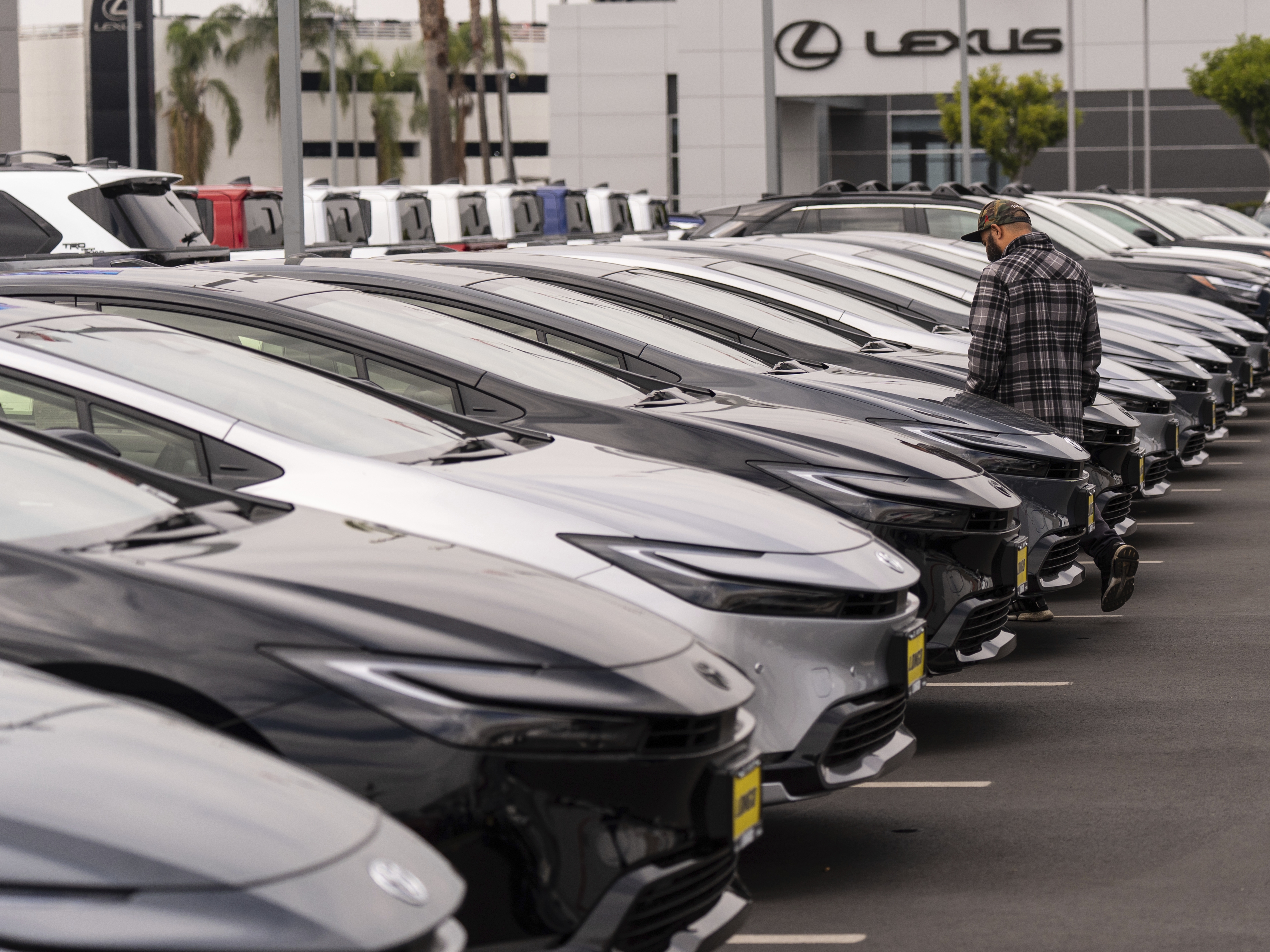 caption: A person looks at a new vehicle at a Toyota dealership in El Monte, Calif., Thursday, March 27, 2025. (AP Photo/Jae C. Hong)