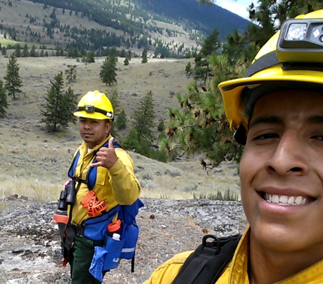 caption: Noe Vasquez, right, on a state wildfire crew in the Okanogan Valley. After Vasquez lost his DACA status and his job, a traffic stop led to immigration custody.