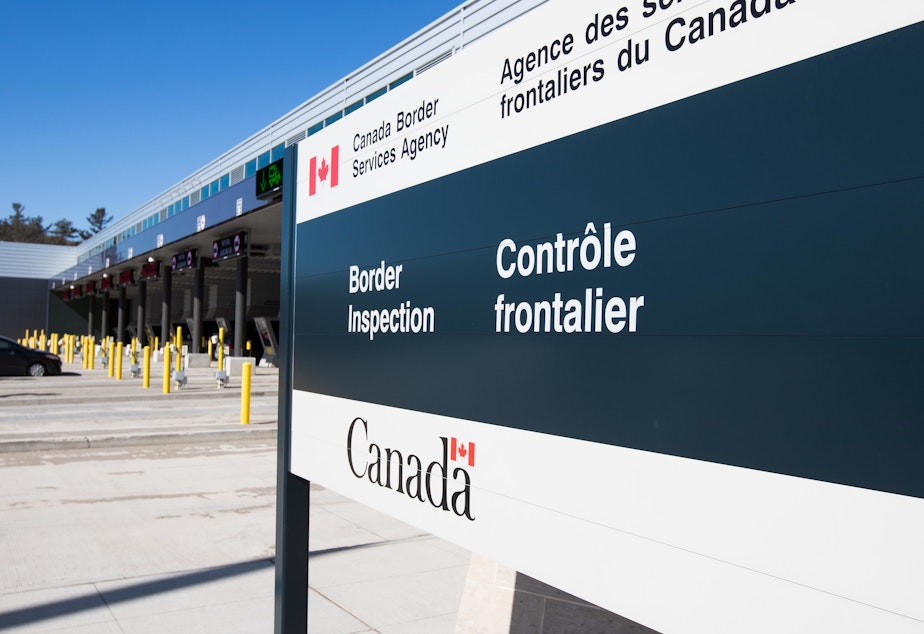 caption: A vehicle enters a Canadian border station at the U.S./Canada border after the two countries closed their border for all non-essential travel in Lansdowne, Ontario, on March 22, 2020.