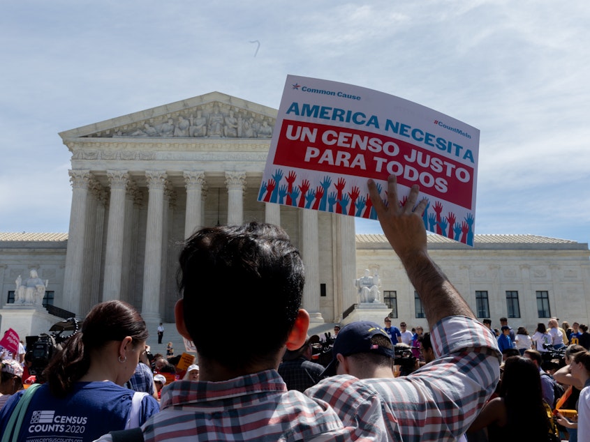 caption: Protesters carrying signs about the census gather outside the U.S. Supreme Court in 2019. Immigrant rights advocates have vowed to continue fighting President Trump's proposal.