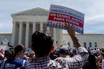caption: Protesters carrying signs about the census gather outside the U.S. Supreme Court in 2019. Immigrant rights advocates have vowed to continue fighting President Trump's proposal.