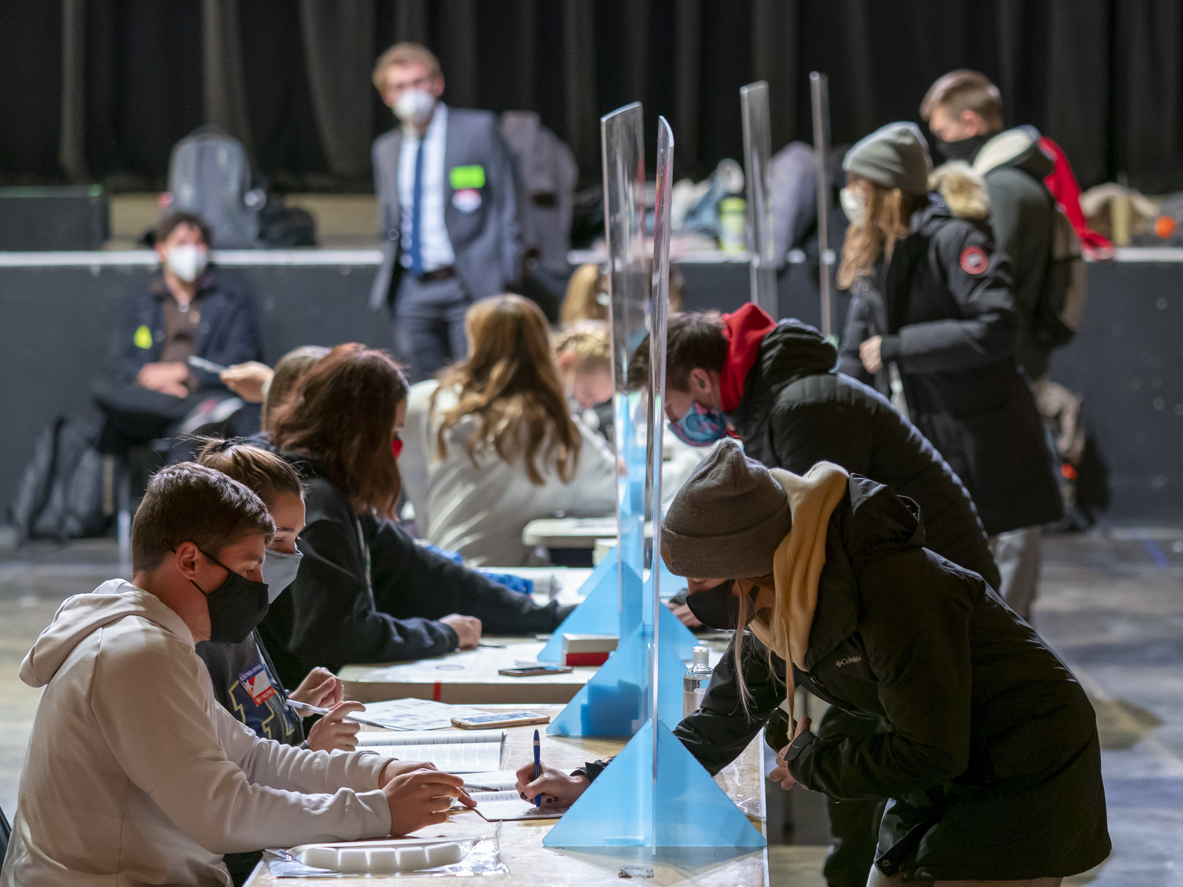 caption: Poll workers check voters identifications at The Orpheum Theater in Madison, Wis., on Election Day. The Trump campaign announced on Wednesday that it is filing for a recount in two counties in the state.