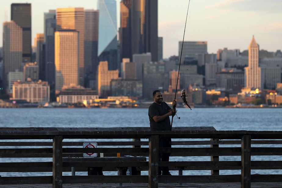 caption: A man who asked not to be identified by name smiles after catching a spotted ratfish while fishing on Thursday, June 29, 2023, in West Seattle.