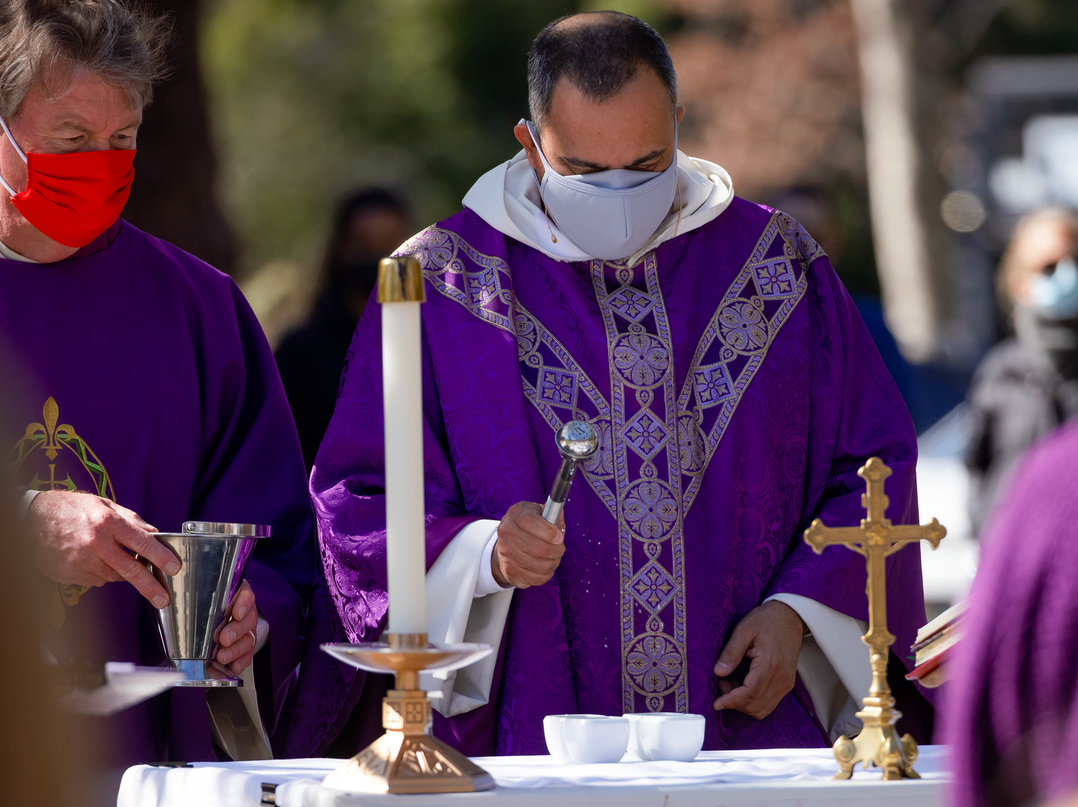 caption: The Rev. Michael Amabisco blesses ashes during an Ash Wednesday service at St. Raymond Catholic Church in Menlo Park, Calif., in February. A new Gallup survey finds that those professing church membership has fallen 18 percentage points among Catholics since 2000.