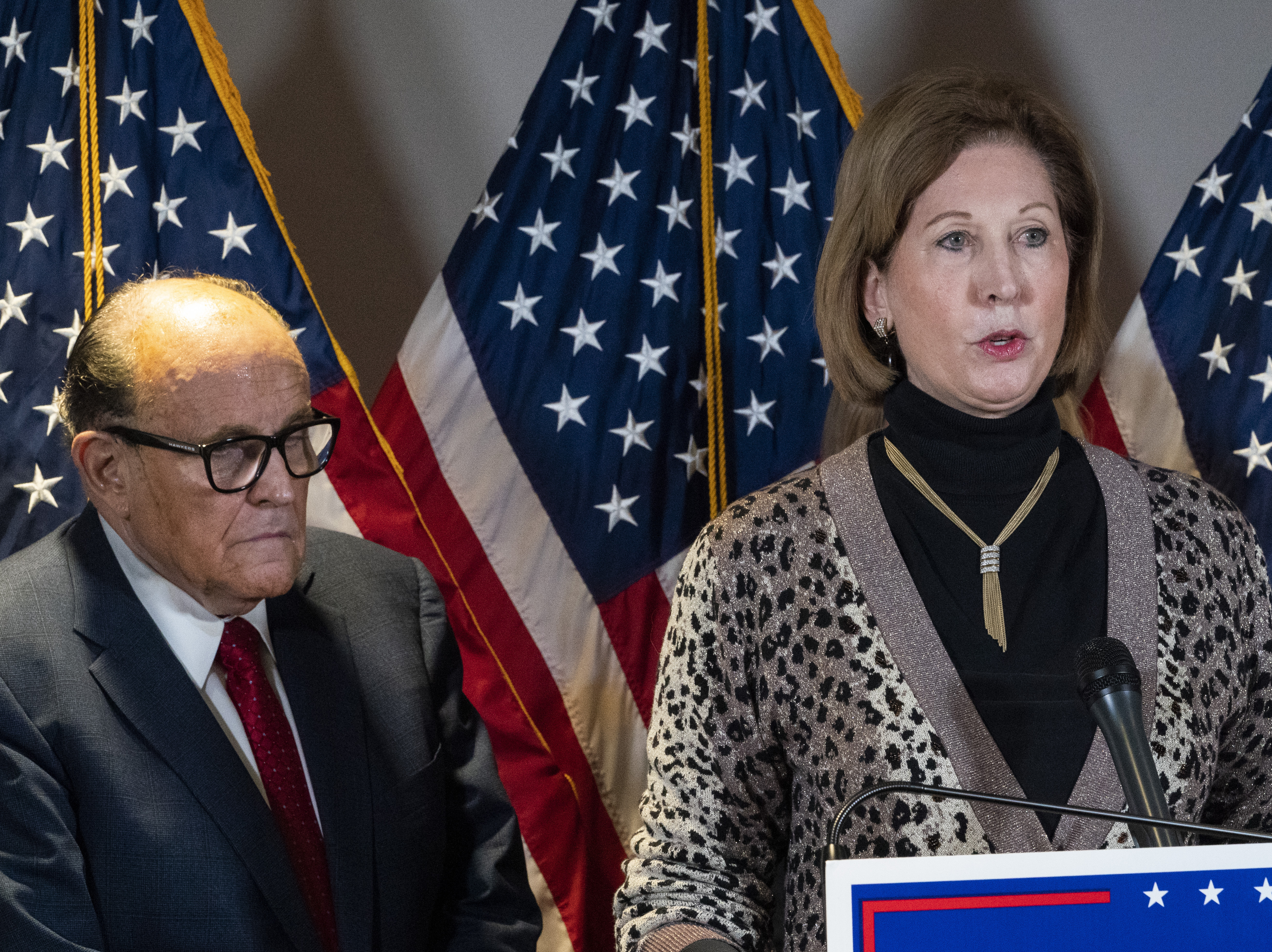 caption: Sidney Powell, right, speaks next to former Mayor of New York Rudy Giuliani, in November.