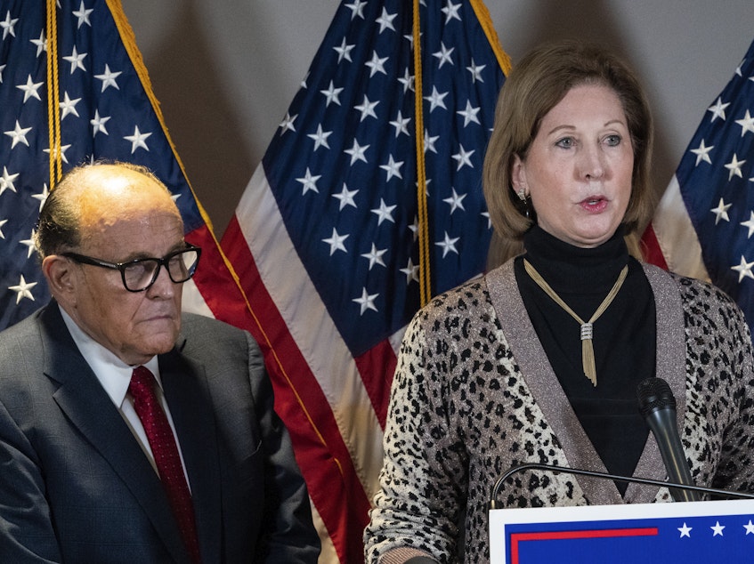 caption: Sidney Powell, right, speaks next to former Mayor of New York Rudy Giuliani, in November.