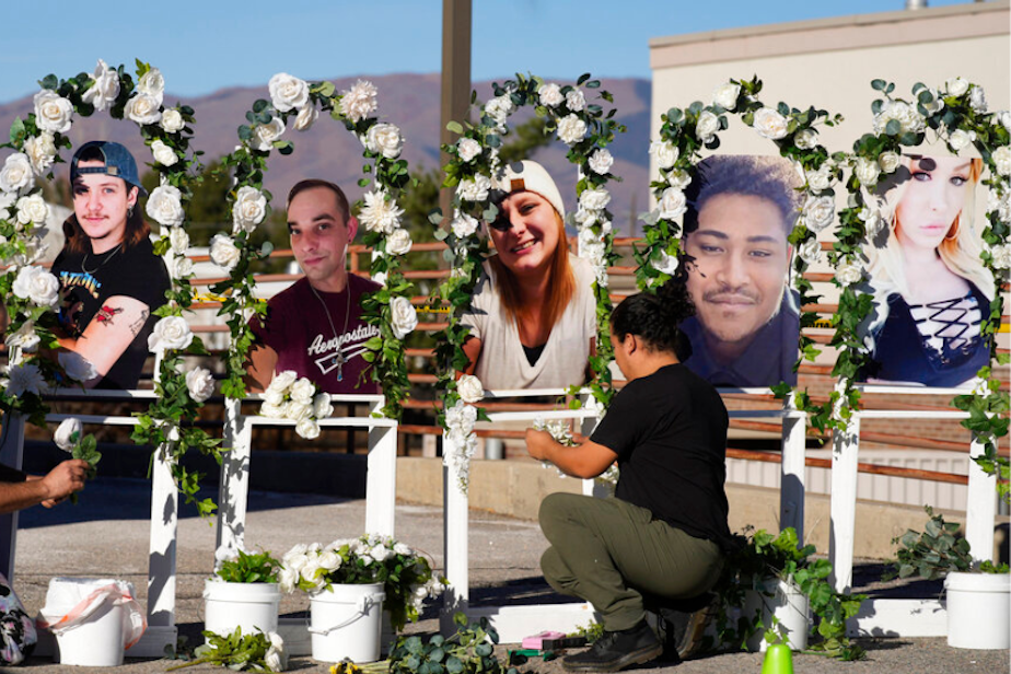 caption: Noah Reich, left, and David Maldonado, the Los Angeles co-founders of Classroom of Compassion, put up a memorial with photographs of the five victims of a weekend mass shooting at a nearby gay nightclub on Tuesday, Nov. 22, 2022, in Colorado Springs, Colo. Anderson Lee Aldrich opened fire at Club Q, in which five people were killed and others suffered gunshot wounds before patrons tackled and beat the suspect into submission. 