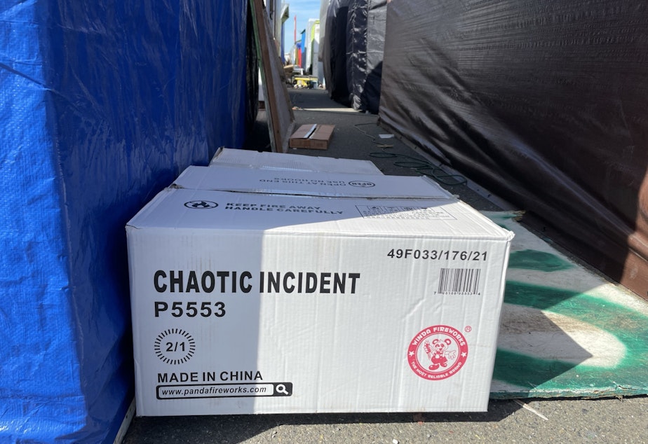 caption: A box of fireworks labeled "Chaotic Incident" at Firecracker Alley, on Puyallup land near the Port of Tacoma.