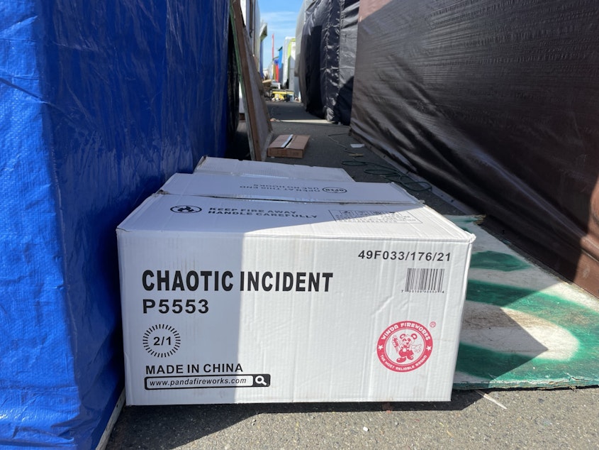 caption: A box of fireworks labeled "Chaotic Incident" at Firecracker Alley, on Puyallup land near the Port of Tacoma.