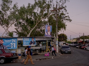 caption: Banner with the face of President Nayib Bukele on the roof of the pupusas restaurant of Arnulfo Crisostomo Mazariego in San Salvador on Jan. 29.