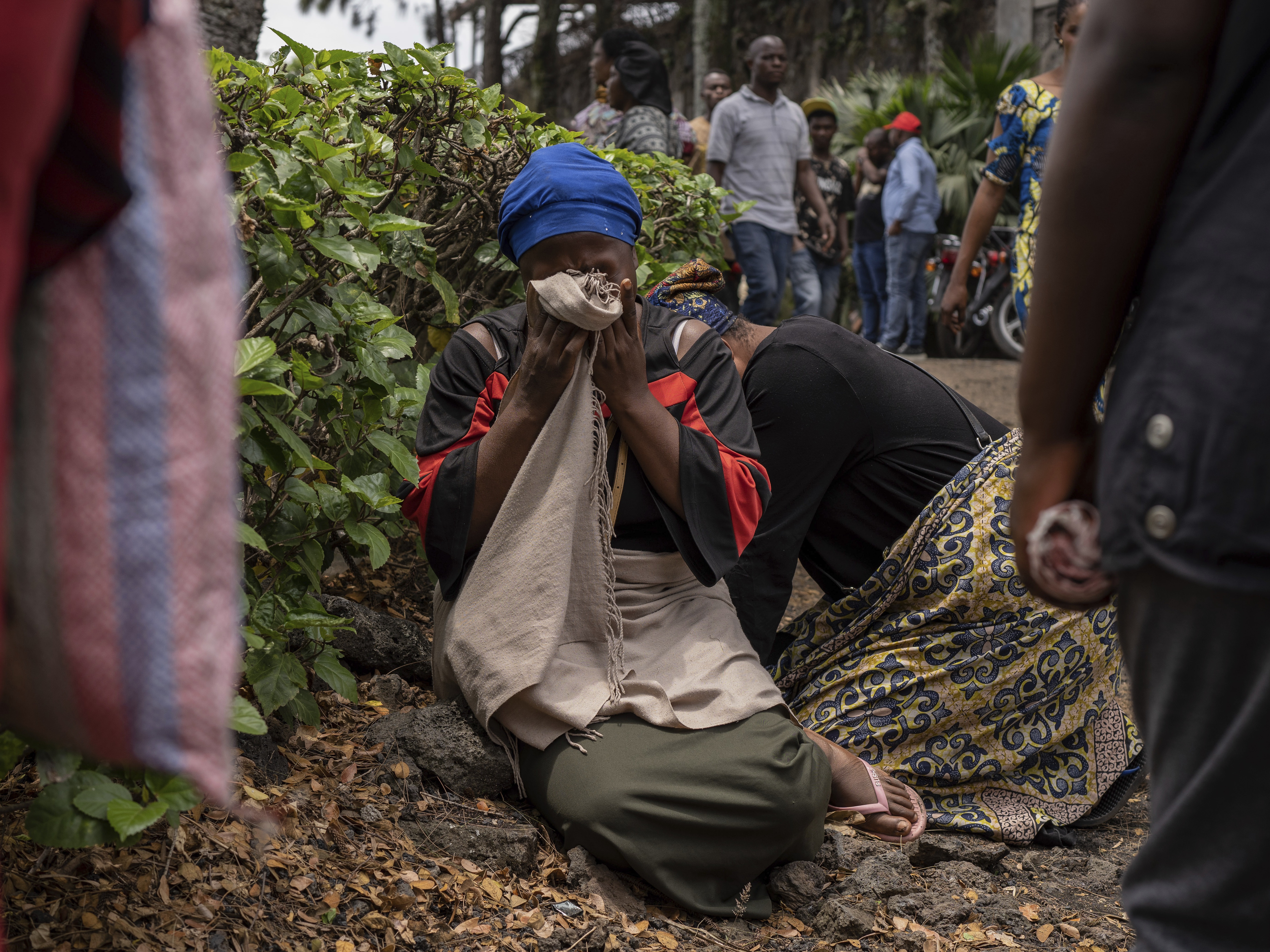 caption: Women grieve at the port of Goma, Democratic Republic of Congo, after a ferry carrying hundreds capsized on arrival Thursday.