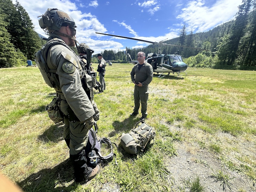 caption: In this handout photo provided by the Snohomish County Sheriff's Office, deputies participate in the search for Travis Decker, at an undisclosed location in Washington state, Friday, June 6, 2025.