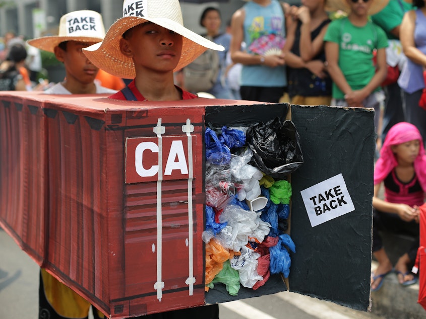 caption: "I want a boat prepared" to take tons of trash back to Canada, Philippines President Rodrigo Duterte said Tuesday. In this 2015 photo, Filipino activists wear shipping container costumes to call on Canada to remove the garbage from a port in Manila.