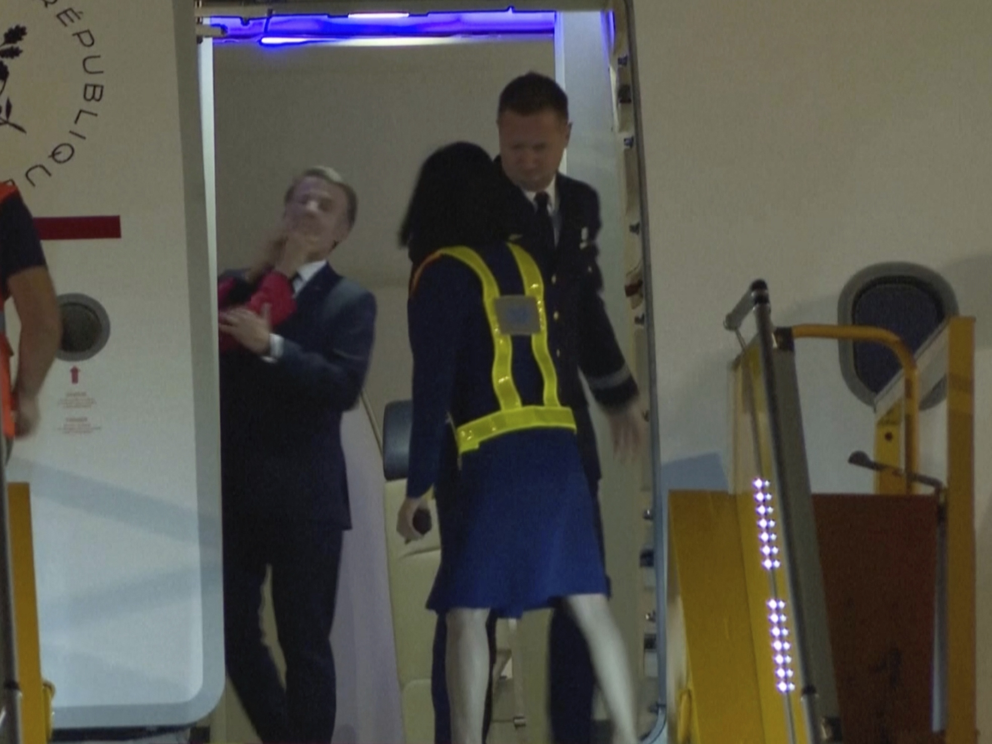 caption: In a grab taken from video, France's President Emmanuel Macron is shoved while preparing to disembark a plane in Hanoi, Vietnam on Sunday.
