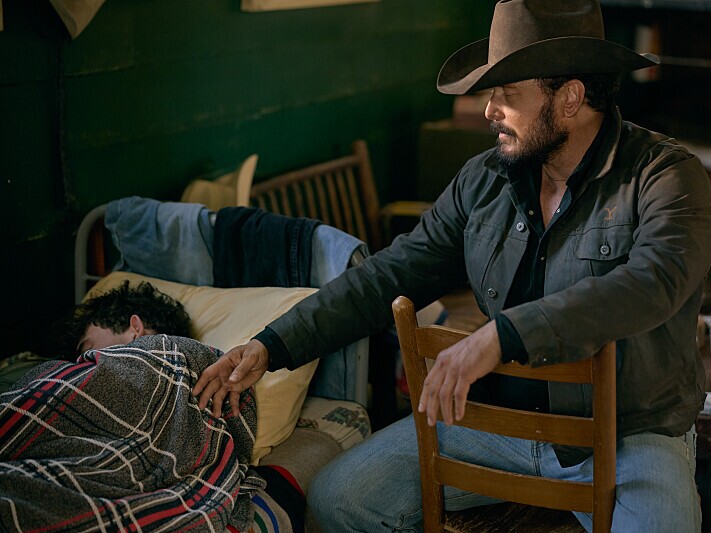 caption: Finn Little as Carter and Cole Hauser as Rip Wheeler.