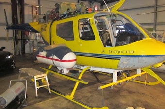 caption: The yellow helicopter belonging to Steve Owen of Pacific Air Research was at the center of an investigation into alleged overspray during an aerial herbicide application onto forestland in Curry County.