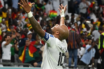 caption: Ghana's André Ayew celebrates after Mohammed Kudus scores the team's third goal in a 2022 World Cup Group H match against South Korea on Monday, Nov. 28, 2022, at the Education City Stadium in Al Rayyan, Qatar.