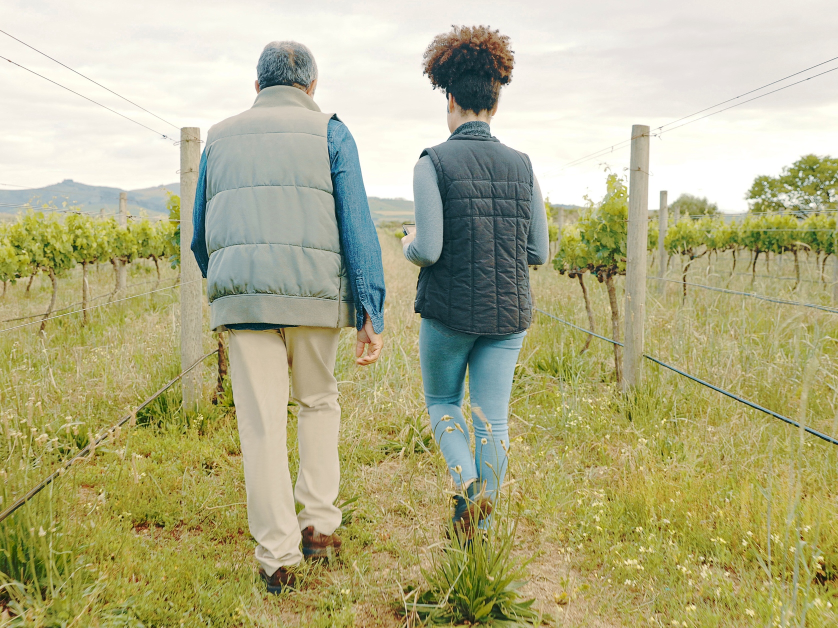 Rearview shot of a man and woman working together on a farm