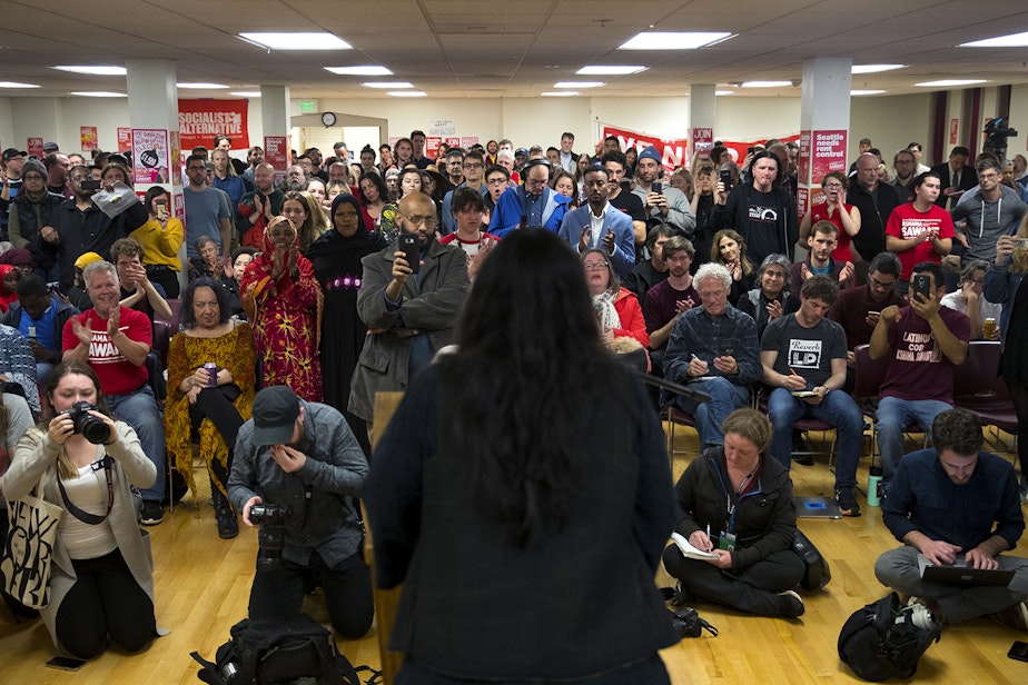caption: Supporters clap for councilmember Kshama Sawant during an election night party on Tuesday, November 5, 2019, at Langston Hughes Performing Arts Institute in Seattle. Sawant trailed her District 3 opponent Egan Orion on election night but has closed the gap in later returns.