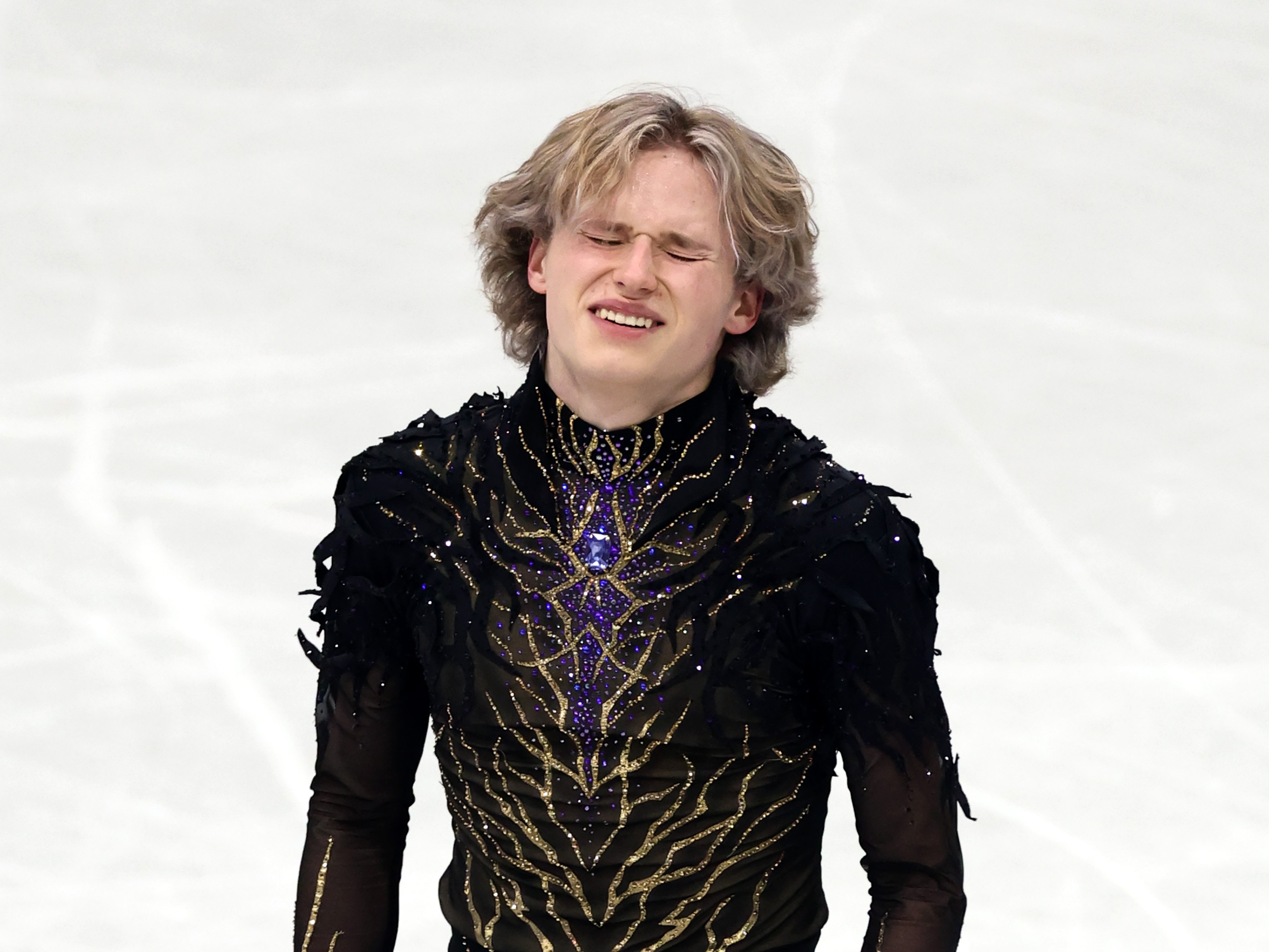 caption: lia Malinin winces after his free skate on Friday.