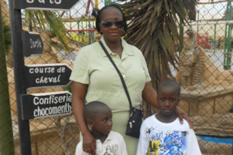 caption: A photo of Amadou Gaye (right), May Gueye (middle) and Idrissa Gaye (left) at an amusement park in Dakar, Senegal, in 2011. 