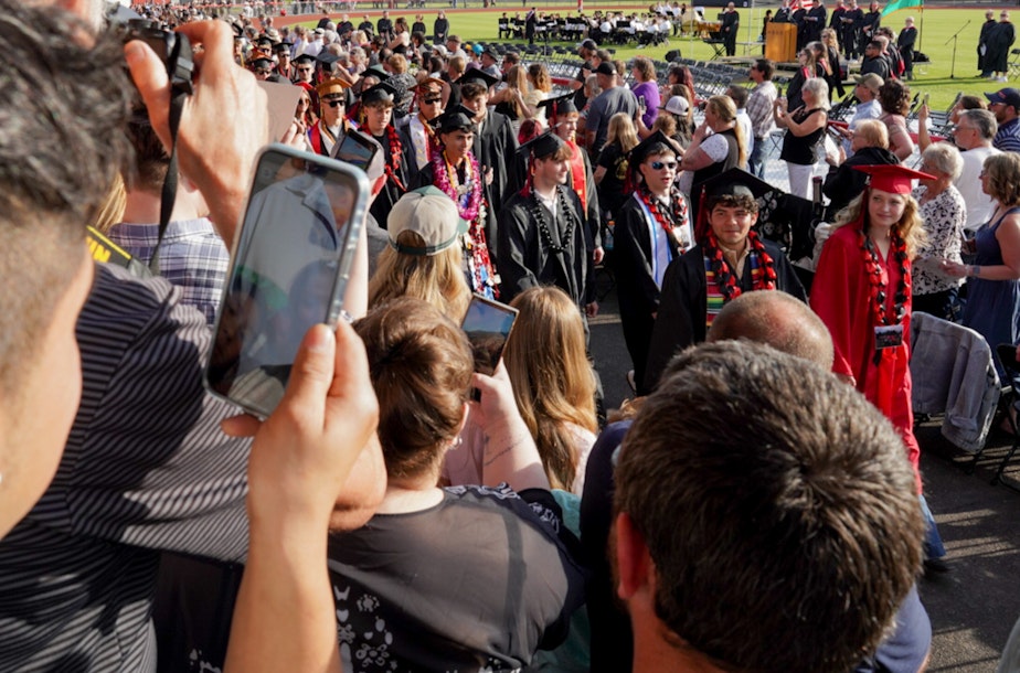 caption: Despite his family not being there physically, they were able to watch Alex Guerrero Villatoro and other students celebrate their graduation Thursday, June 5.
