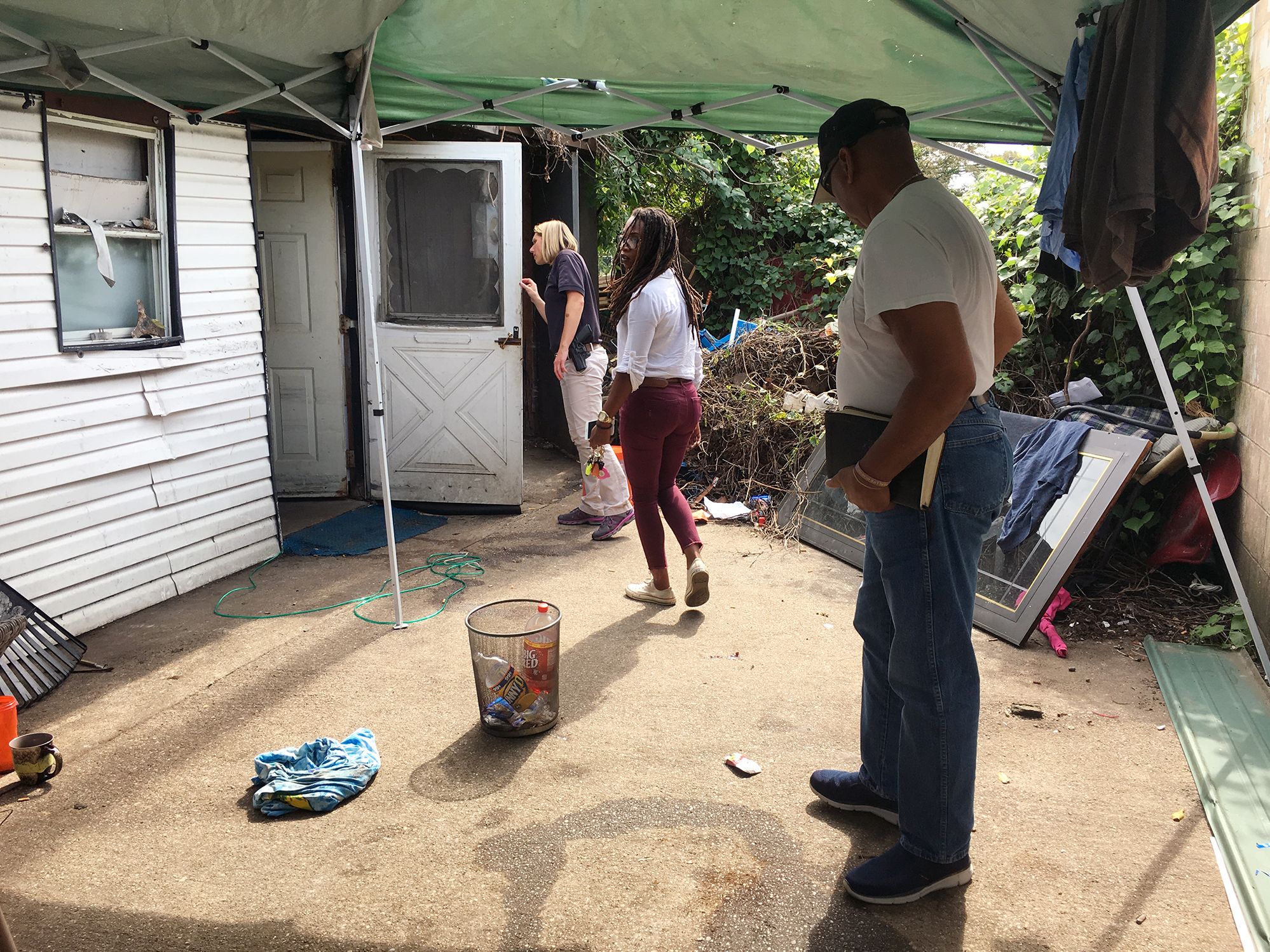 caption: Paramedic Larrecsa Cox (center) and her quick-response team, including police Officer Stephanie Coffey (left) and Pastor Virgil Johnson (right), check in at the home in Huntington, W.Va., of someone who was revived a few days before from an overdose.
