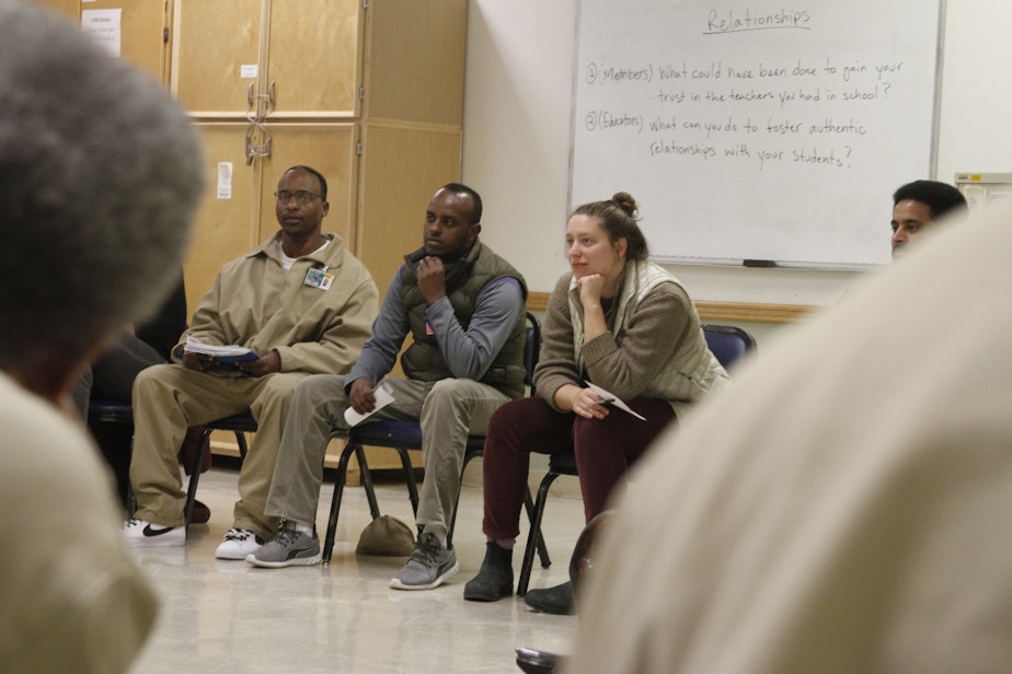 caption: Teachers and inmates listen to each others' stories of school experiences good - and bad - at Monroe Correctional Complex on March 1, 2019.