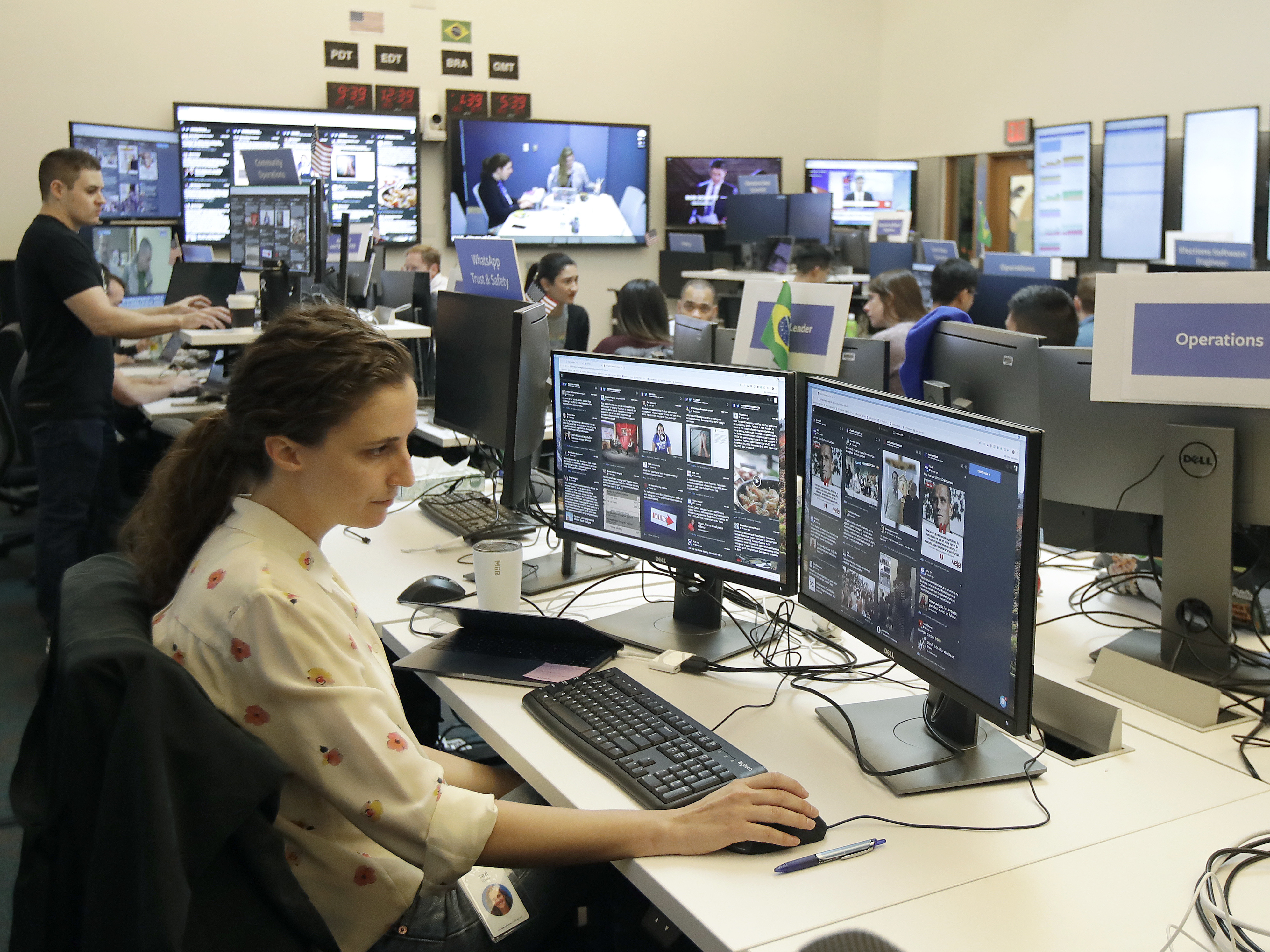 caption: Lexi Sturdy, election war room lead, sits at her desk during a demonstration in the war room, where Facebook monitors election related content on the platform, in Menlo Park, Calif., Wednesday, Oct. 17, 2018.