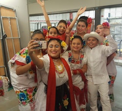 caption: Teacher Luna Garcia with Joyas Mestizas dancers