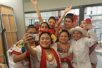 caption: Teacher Luna Garcia with Joyas Mestizas dancers
