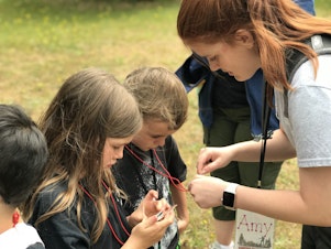 caption: Amy Miseli, here teaching map and compass skills to Cub Scouts, plans to attend the BSA Boot Camp at Camp Thunderbird.  Courtesy of Amanda Lafferty 