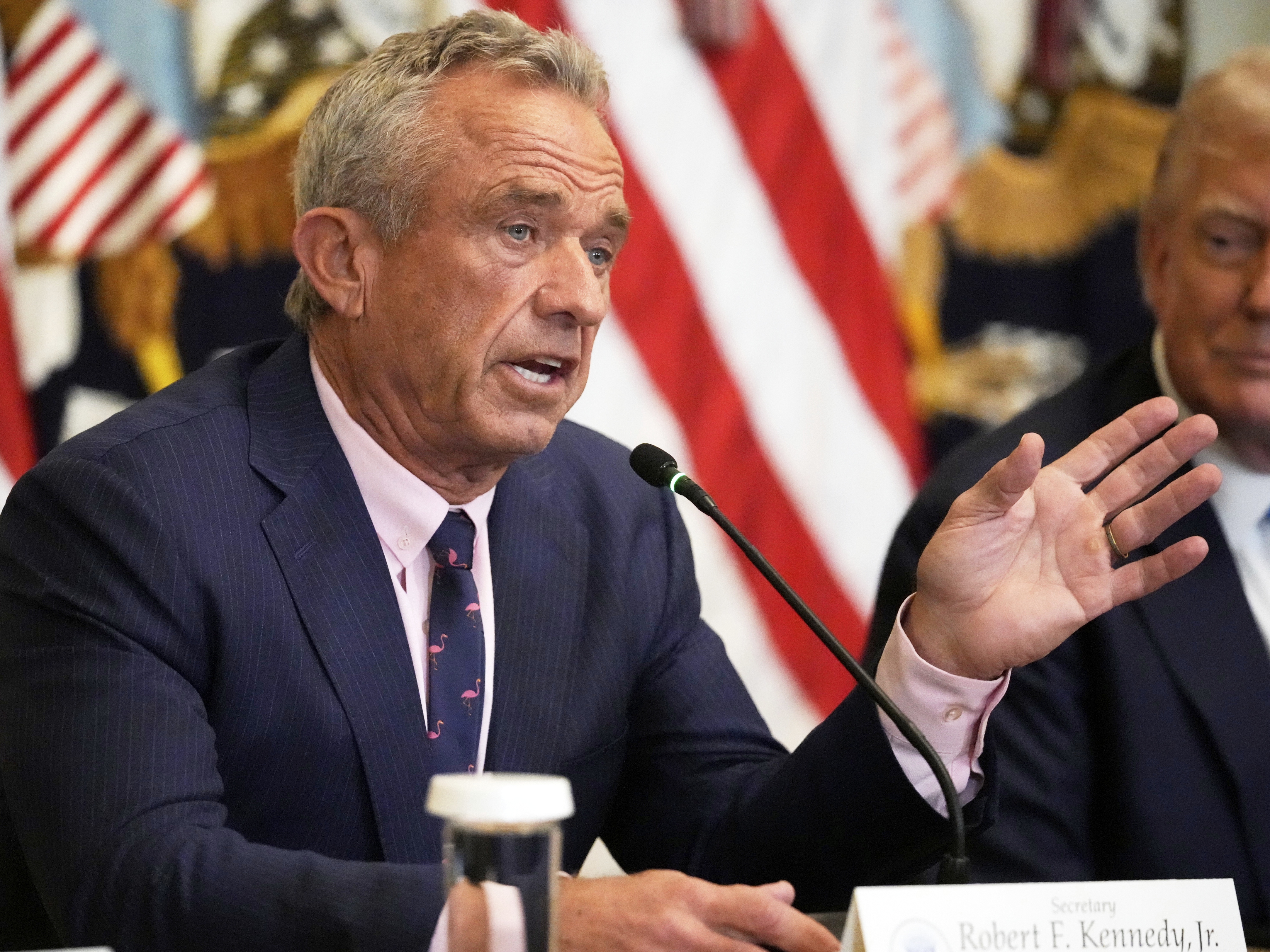 caption: Health and Human Services Secretary Robert F. Kennedy Jr. speaks as President Donald Trump listens at an event to promote his proposal to improve Americans' access to their medical records in the East Room of the White House, Wednesday, July 30, 2025, in Washington.