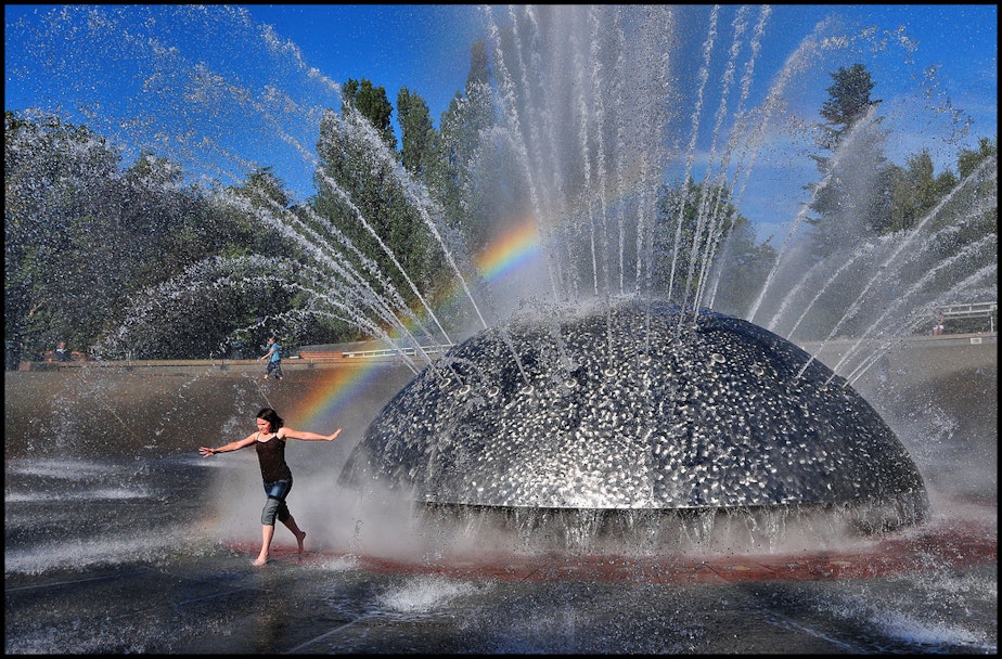 caption: Staying cool in the International Fountain at Seattle Center is one way to beat the heat.