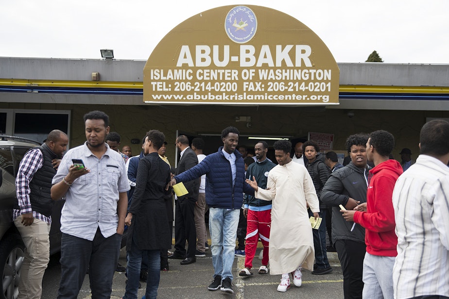 caption: Men exit the Abu-Bakr Islamic Center after prayer on Friday, April 20, 2018, in Tukwila.