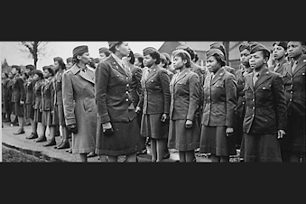 caption: Major Charity Adams and Captain Abbie Campbell inspect the first contingent of Black women assigned to overseas service in the Women's Army Corps, in England in February 1945.