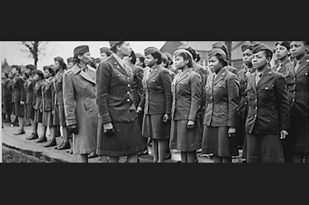 caption: Major Charity Adams and Captain Abbie Campbell inspect the first contingent of Black women assigned to overseas service in the Women's Army Corps, in England in February 1945.