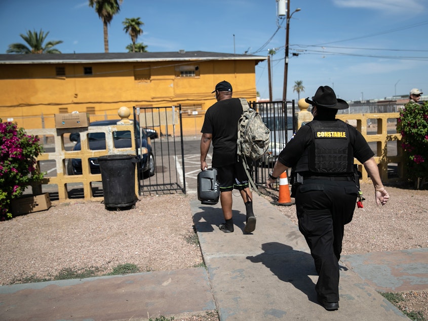 caption: Maricopa County constable Darlene Martinez evicts a tenant on October 7, 2020 in Phoenix, Arizona. Thousands of court-ordered evictions continue nationwide despite a Centers for Disease Control (CDC) moratorium for renters impacted by the coronavirus pandemic.