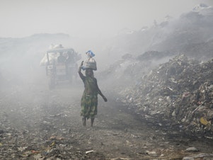 caption: People work at a landfill in India that's full of plastic bags. Members of the United Nations are negotiating a treaty that's aimed at cutting plastic pollution globally.