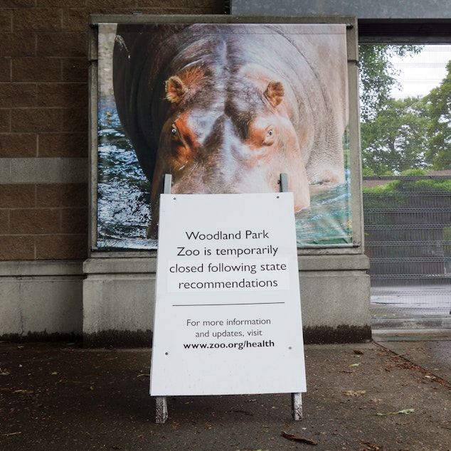 caption: A sign at the Woodland Park Zoo in Seattle explains the closed gates behind it. The zoo reopened to members in late June and began admitting non-members by appointment on July 1. During earlier stages of the lockdown, zookeepers struggled to provide mental stimulation to some of the animals.