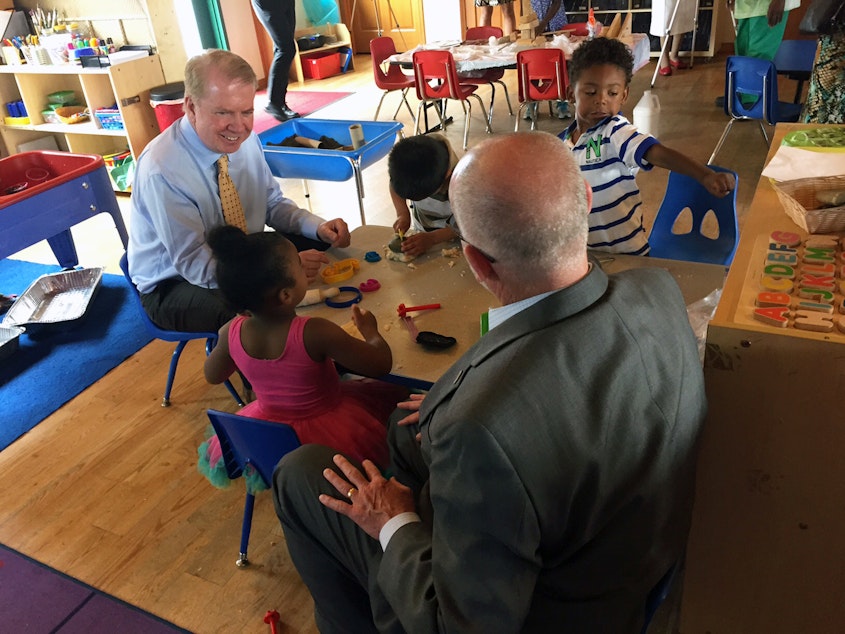 caption: Seattle Mayor Ed Murray and City Councilmember Tim Burgess chat over playdough with preschoolers in July 2015 at Causey's Learning Center, one of the first Seattle Preschool Program providers. 