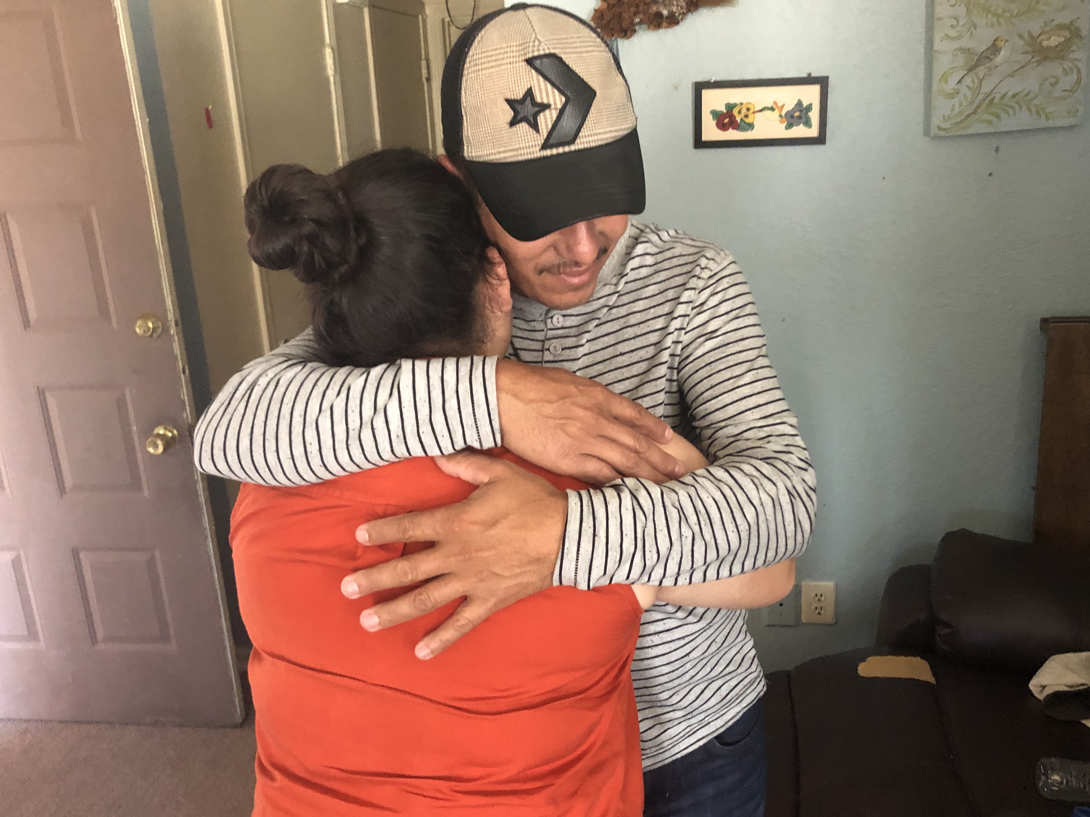 caption: Jose Eduardo hugs his 15-year-old daughter Yaimy, 10 months after they were separated at the U.S. border.