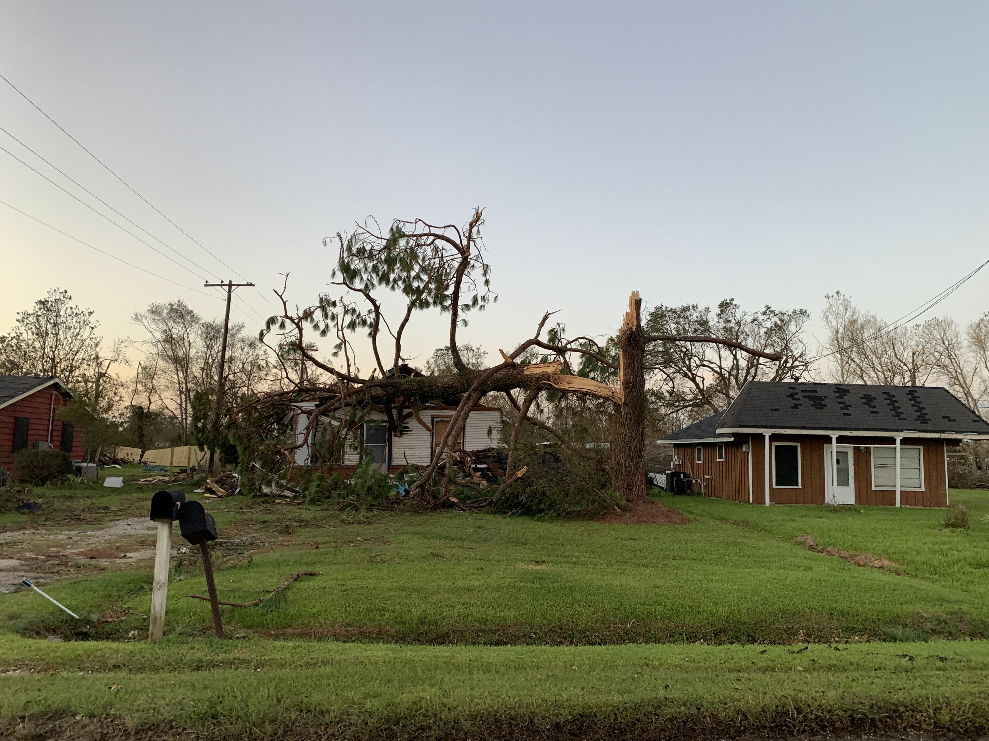 caption: A home near Iowa, La., was crushed by a snapped tree after Hurricane Laura made landfall with 150 mile-per-hour winds Thursday. The area is facing two disasters at once.