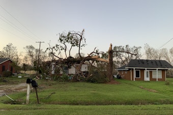 caption: A home near Iowa, La., was crushed by a snapped tree after Hurricane Laura made landfall with 150 mile-per-hour winds Thursday. The area is facing two disasters at once.
