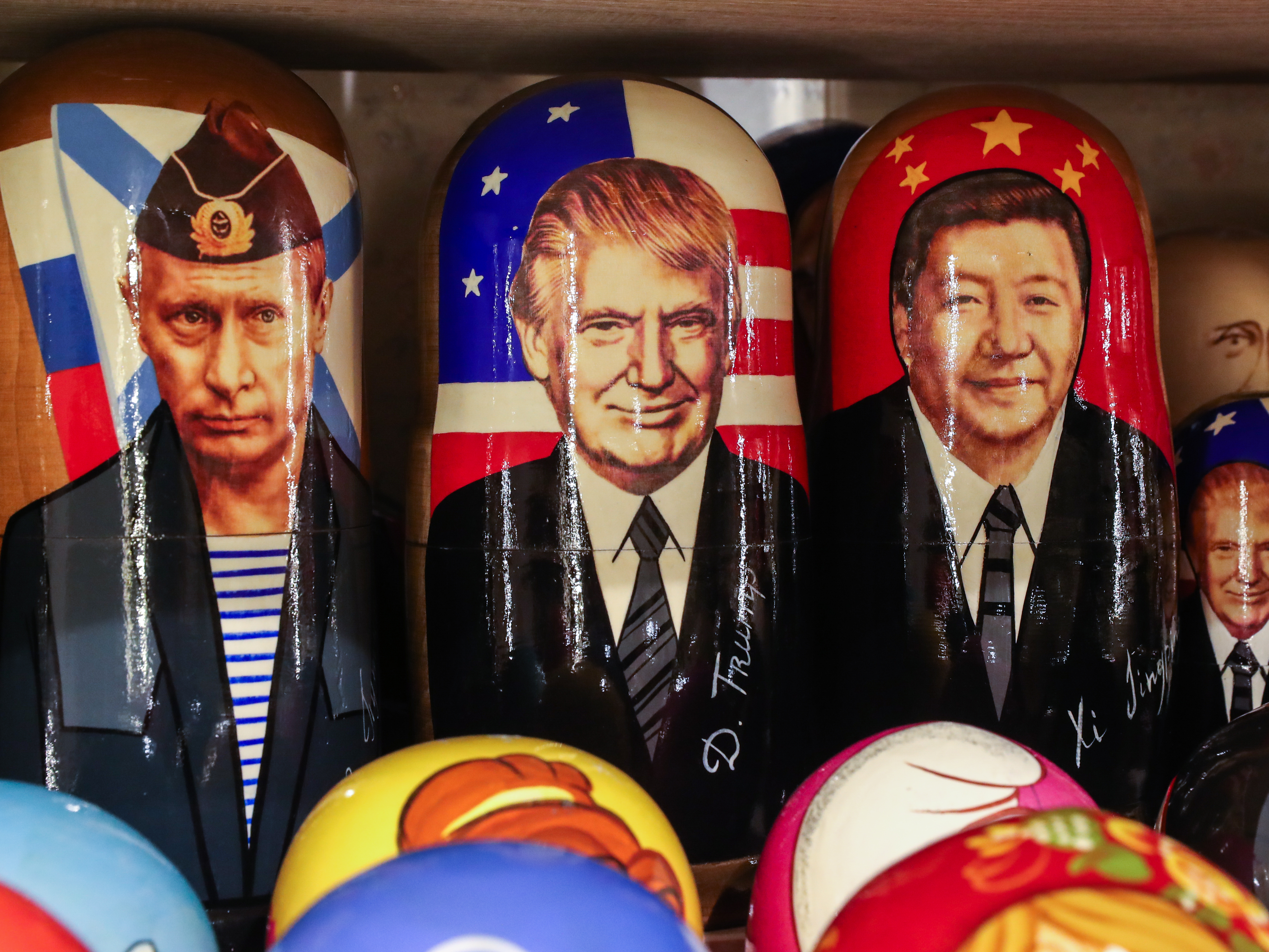 caption: Russian dolls with the likenesses of Russia's President Vladimir Putin, President Trump and China's President Xi Jinping at a gift shop in Russia. While many world leaders have congratulated President-elect Joe Biden, Russia and China have held off.