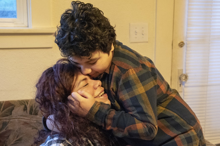 caption: Carolina Landa hugs her son, Zach, in their living room before he leaves for school on Monday, Feb. 25, 2019. The two have been living together in the same home in Olympia since 2015. 