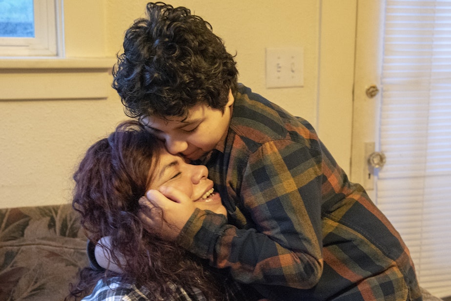 caption: Carolina Landa hugs her son, Zach, in their living room before he leaves for school on Monday, Feb. 25, 2019. The two have been living together in the same home in Olympia since 2015.